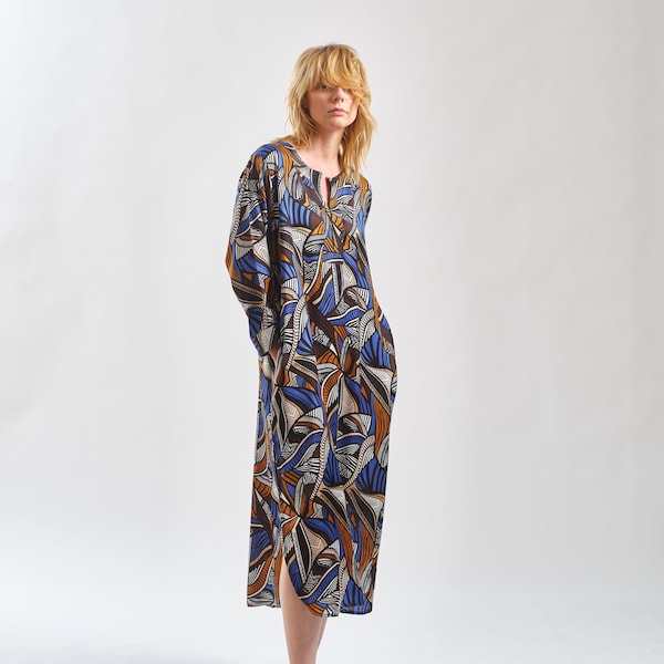 100% Viscose Bemberg 3/4 Sleeve Split Neck Calf Length Side Slit African Wax Print Inspired Tunic Dress. Limited Pieces Produced.