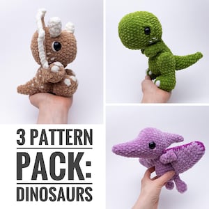 May include: A collection of three crocheted dinosaur toys in various colors. The dinosaurs include a brown triceratops, a green T-Rex, and a purple pterodactyl. The image also includes the text "3 PATTERN PACK: DINOSAURS."