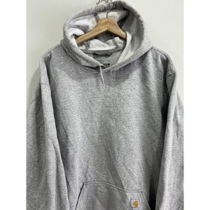 May include: A grey hooded sweatshirt with a small yellow Carhartt logo on the front pocket.
