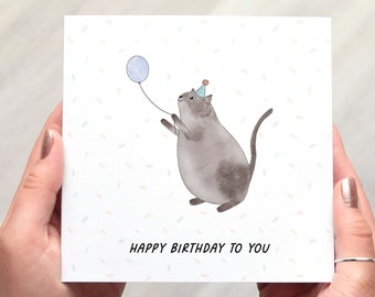 Cat Birthday Card, square birthday card with a cute cat illustration, the cat holds a balloon in this fun whimsical design
