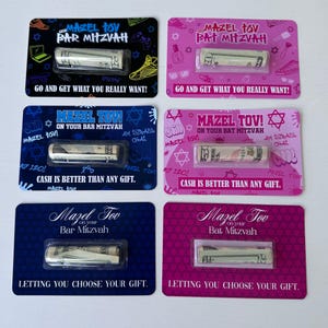 May include: Four colourful cards with a cash gift inside. Each card has a different design with the text "Mazel Tov" and "Bar Mitzvah" or "Bat Mitzvah".