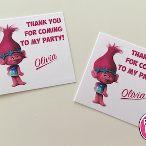 May include: Two pink and blue Trolls thank you cards with the text "Thank you for coming to my party!" and the name "Olivia" on each card.