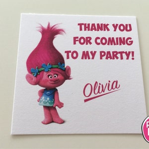 May include: Pink Trolls character thank you card with the text "Thank you for coming to my party!" and the name "Olivia" printed in pink. The card is from Romi Lipo.