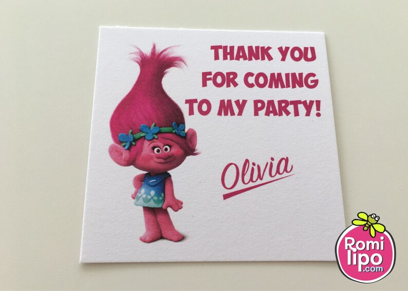 May include: Pink Trolls character thank you card with the text "Thank you for coming to my party!" and the name "Olivia" printed in pink. The card is from Romi Lipo.