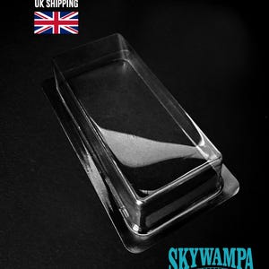 May include: A clear, rectangular plastic blister pack tray with a flat rim and a hollow center. The image includes the text UK SHIPPING with a Union Jack flag, and the text SKYWAMPA with the website address WWW.SKYWAMPA.COM at the bottom.