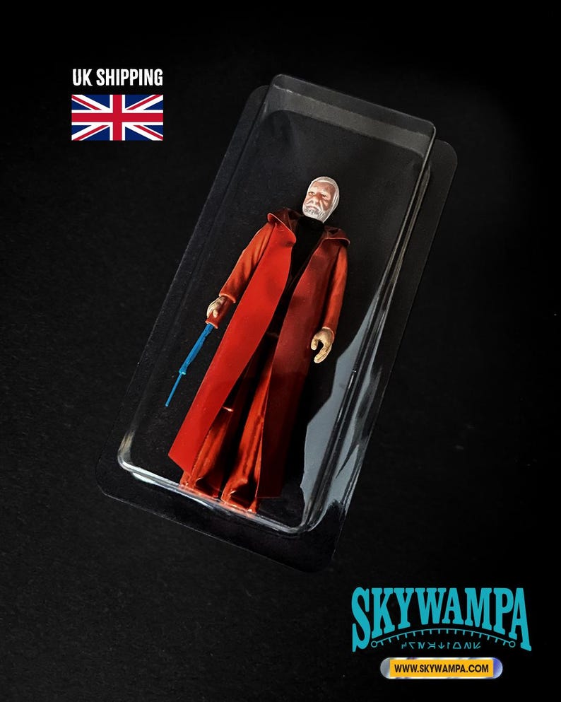 May include: A plastic action figure of a bearded character with a white head, wearing a long red coat over a black shirt, holding a thin blue rod. The figure is encased in a clear plastic blister pack. The text SKYWAMPA and WWW.SKYWAMPA.COM appear.
