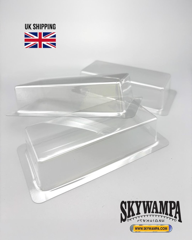 May include: Two clear, rectangular plastic blister pack inserts with a raised central cavity and a flat surrounding flange. The transparent packaging components are stacked slightly offset, showcasing their smooth, molded, and rigid structure.
