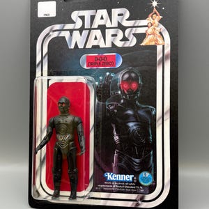 May include: A set of three ceramic mugs with a speckled, matte finish. The mugs are in shades of cream, light gray, and dark gray. Each mug has a simple, minimalist design and a rounded handle.