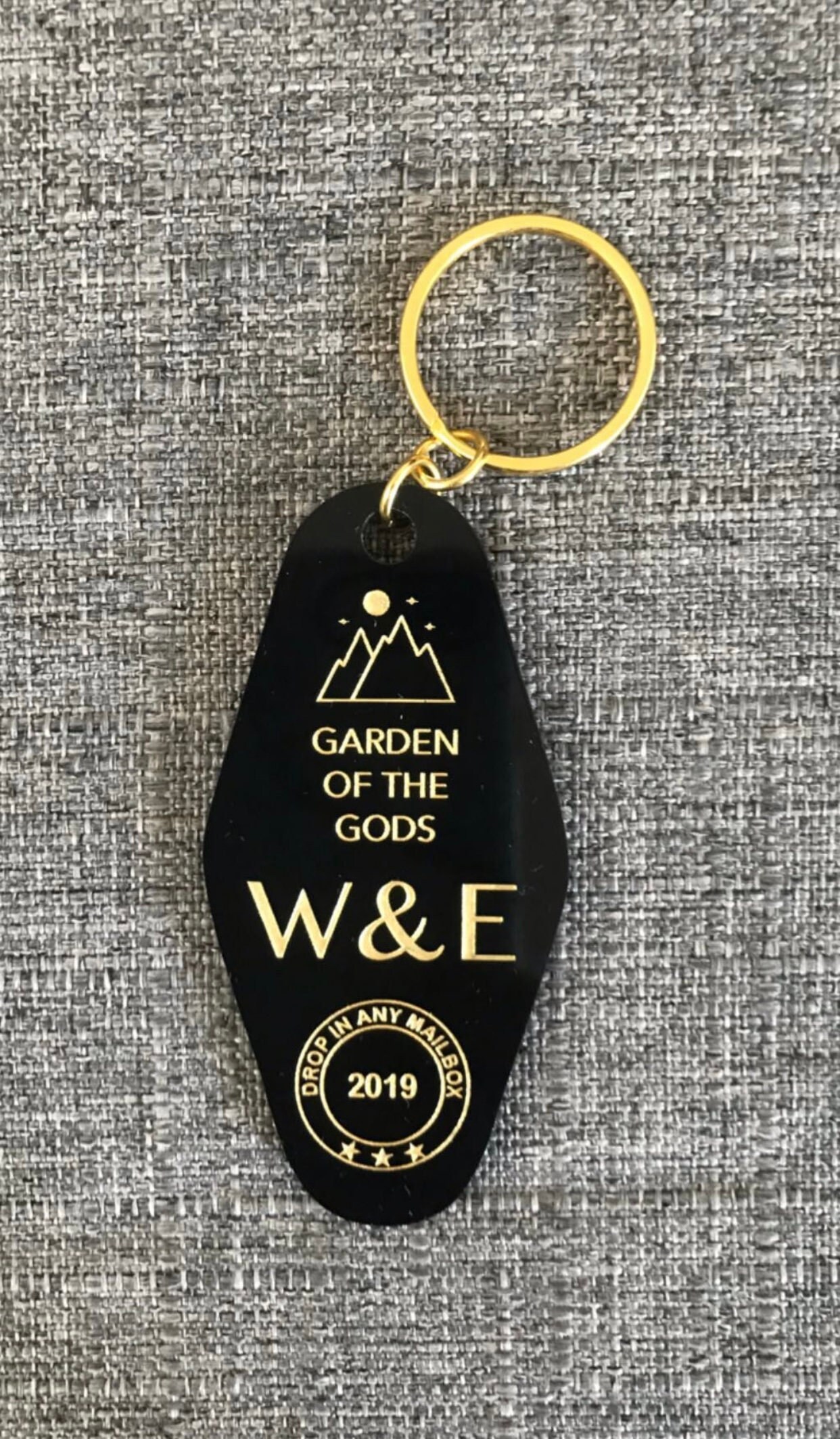 black or white custom motel keychain with gold lettering