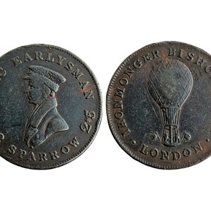 May include: A copper token with a portrait of Isaac Early, a balloonist, on one side and a hot air balloon on the other. The text on the token reads "Isaac Early, 1801,  Sparrow 2/6" and "Ironmonger Bishop's Gate, London".