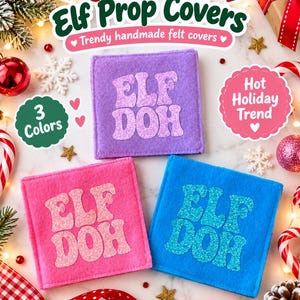 May include: Three square felt covers in purple, pink, and blue, each featuring the glittery text ELF DOH. The purple cover has light purple text, the pink cover has light pink text, and the blue cover has light blue text. These are flat items.