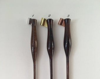 May include: Three wooden calligraphy pens with different colored metal nibs. The pens are numbered 1, 2, and 3.