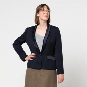 May include: A navy blue blazer with a satin lapel and a brown tweed skirt.