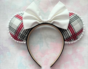 May include: Red and white plaid fabric mouse ears with a white bow. The headband is black.