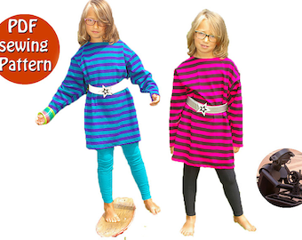 May include: PDF sewing pattern for a striped tunic with long sleeves. Two children are wearing the tunic, one in blue and white stripes and the other in pink and black stripes. Both tunics have a white belt with a star buckle.