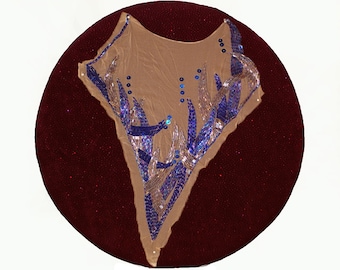 May include: A sheer fabric garment with a blue and silver beaded design. The garment is displayed on a red velvet background.