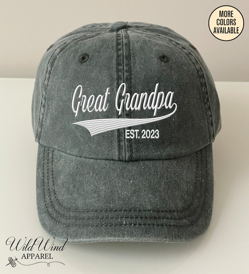 May include: A black washed cotton baseball cap with white embroidered text that reads "Great Grandpa Est. 2023".