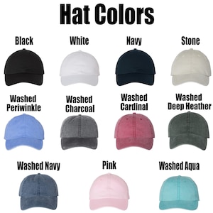 May include: A chart showing 12 different colors of baseball caps. The colors include black, white, navy, stone, washed periwinkle, washed charcoal, washed cardinal, washed deep heather, washed navy, pink, and washed aqua.
