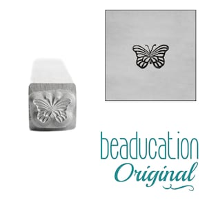 May include: A metal stamping tool with a square shaft featuring a butterfly design on the end. The tool creates a butterfly impression, shown in a black and white square inset. The text beaducation Original appears in teal below the tool.