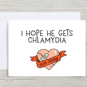 May include: A white card with a red heart with a bandage on it and the text "I hope he gets chlamydia not sorry".