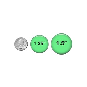 a penny and two green buttons with the same size