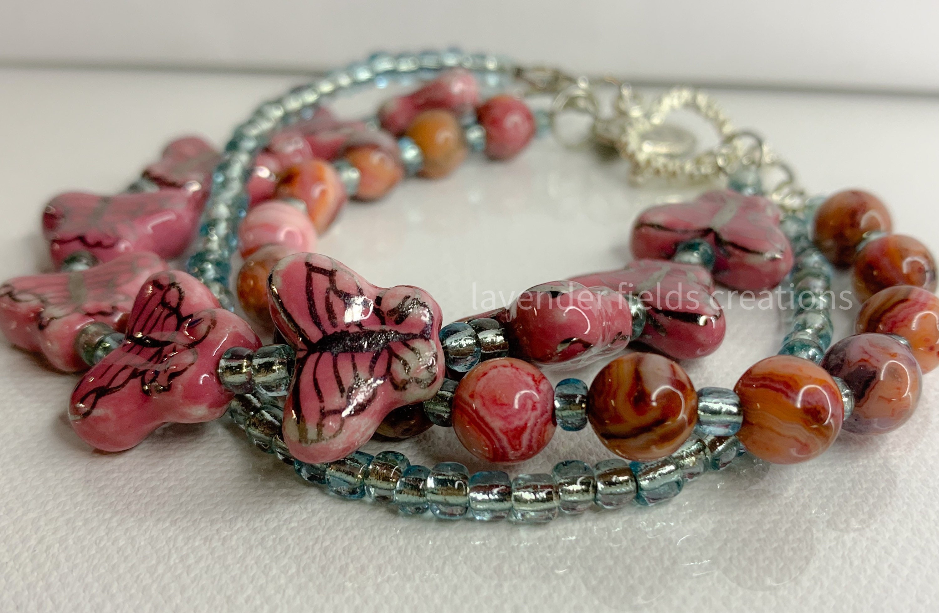 MOREL PINK BEADS BRACELET WITH PINK AND BROWN BUTTERFLY PENDANT