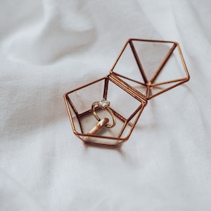geometric glass ring holder for special engagement ceremony made of transparent glass