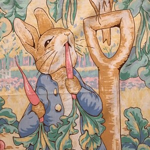 May include: A whimsical illustration featuring Peter Rabbit in a blue jacket, enjoying a carrot. A bird perches on a shovel, with a backdrop of lush greenery and a soft, pastel color palette. The scene evokes a storybook feel.