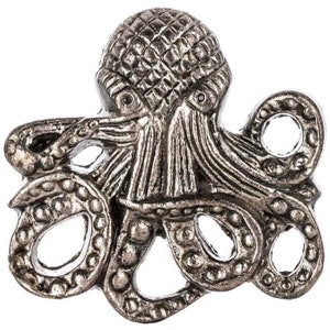 May include: A detailed, silver-toned octopus-shaped decorative object. The octopus has a textured head and tentacles with open circular designs. The object is likely a decorative pin, brooch, or embellishment, showcasing a nautical or marine theme.