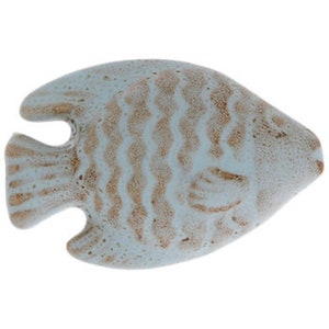 May include: A ceramic fish figurine in a light blue and brown color scheme. The fish has a textured surface with a scale pattern and is designed with fins and a tail. The figurine is likely a decorative item.