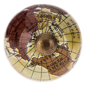 May include: A decorative globe-shaped cabinet knob with a brass-colored base. The globe features a map of the world in shades of brown, tan, and yellow, with continents and country names visible. The knob is designed for furniture or decor.