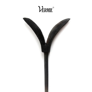 May include: A dark, matte black metal tool featuring a Y-shaped head with two curved, pointed prongs extending upward from a central stem. The word VERMIL is printed in black text above the tool against a plain white background.