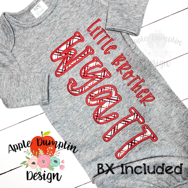 May include: A gray baby onesie with long sleeves. The onesie features the embroidered text "Little Brother Wyatt" in red thread with a plaid pattern. The design includes the text "BX Included" in black.