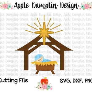 May include: A digital cutting file design featuring a baby Jesus sleeping in a manger with a star above. The design includes the text "Apple Dumplin Design" and "Cutting File" and "SVG, DXF, PNG".