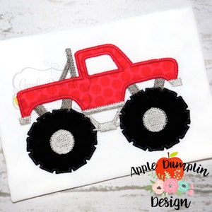 May include: Red monster truck applique with black tires and a gray rim. The truck has a red polka dot pattern on the body.