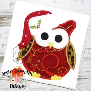 May include: Red and white Christmas owl with a Santa hat, gold swirl pattern, and black eyes. The owl is wearing a brown and gold leopard print scarf.