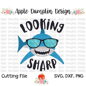 Puede incluir: Un tiburón azul con gafas de sol y una sonrisa de dientes, que dice "Looking Sharp". La imagen incluye el texto "Apple Dumplin Design" y "Cutting File, SVG, DXF, PNG".