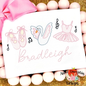 May include: White embroidered design with a swan, ballet shoes, and a ballerina dress. The name "Bradleigh" is embroidered below the design.