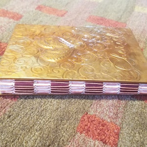 Small handbound notebook with metal covers