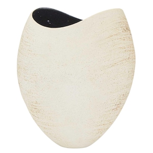 May include: Cream-coloured, oval-shaped vase with a textured surface and a black interior. The vase has a unique, asymmetrical design, perfect for displaying flowers or as a decorative accent piece. The exterior has a speckled, aged appearance.