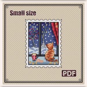May include: A cross stitch pattern titled Winter evening featuring a stamp-shaped design of a cat looking out a window at a snowy landscape. The image includes a red mug, red curtains, and trees. The pattern measures 2.5 x 3.3 inches with 26 DMC colors.