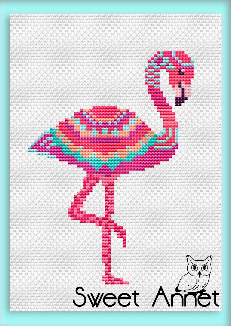 May include: A cross-stitch flamingo in pink, teal, and orange. The bird is depicted standing on one leg. The image includes the text "Sweet Annet" at the bottom, accompanied by a small owl illustration.