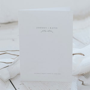 Order of service printed wedding programme with branch illustration detail.