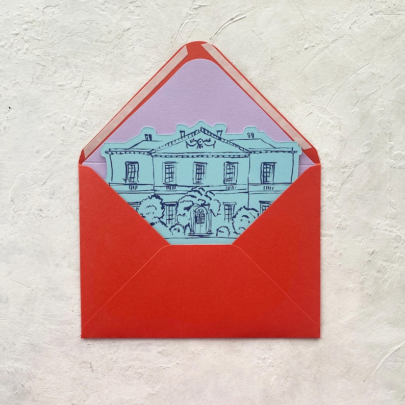 May include: A red envelope with a light purple interior holds a blue illustration of a stately building. The envelope is open, revealing the card with the building design. The background is a textured white surface.