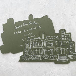 May include: Olive green 'Save the Dates' cards with a white illustration of a stately home. The cards are die-cut in a unique shape. Text on the card reads 'Save the Dates' and the wedding date.