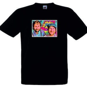 May include: Black t-shirt featuring a comic book style image of two men. The men are wearing casual clothing and have a surprised expression on their faces. The image is surrounded by a colourful background with a large "POW!" in the centre.