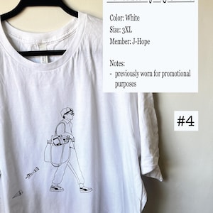 May include: White t-shirt with a black line drawing of a person carrying a bag. The text "Did You See My Bag: Ch 1 Tee" is printed on the shirt. The text "Color: White", "Size: 3XL", "Member: J-Hope", "Notes: - previously worn for promotional purposes" and "#4" are printed on a white background.