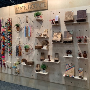 Modern Wooden Pegboard Wall Display for Home Organization and Retail Merchandising