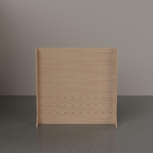 May include: A light-colored wooden pegboard display stand featuring a rectangular front panel with a grid of evenly spaced circular holes. The structure includes two side supports that extend slightly forward at the base for stability.