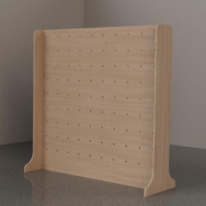 May include: A light-colored wooden pegboard display stand featuring a rectangular panel with a grid of evenly spaced circular holes. The structure includes two side supports with curved bases, providing stability for the upright wooden board.